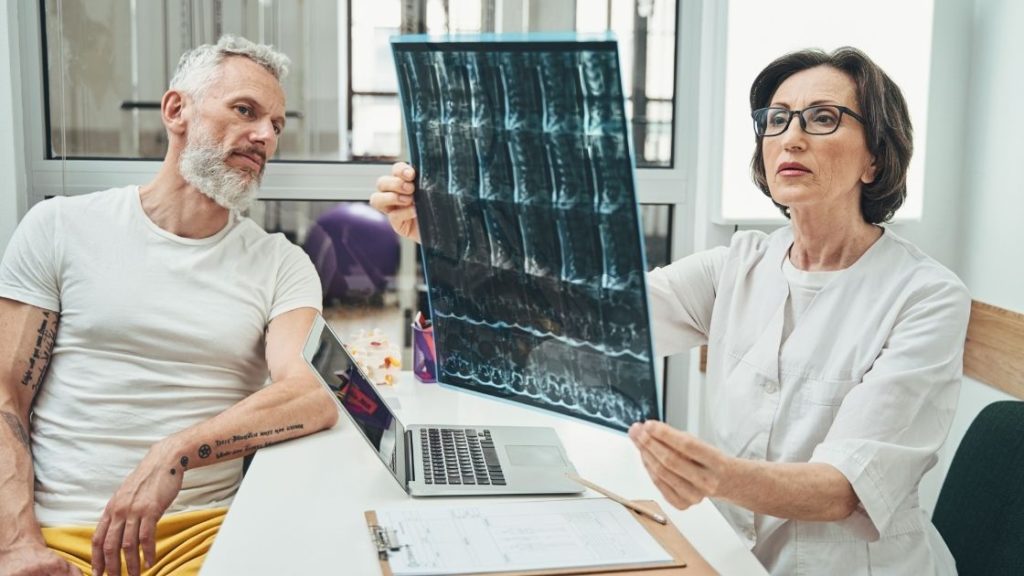 A doctor performing an osteopathic assessment