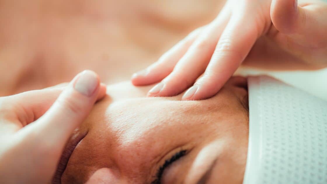 A woman receiving TMJ Massage.